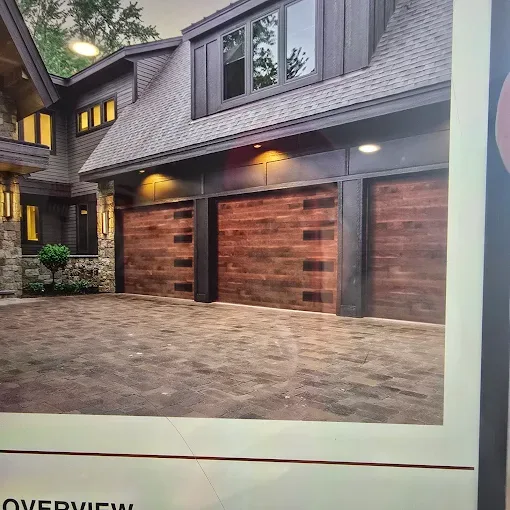 Premium wood plank garage doors on luxury home by Affordable Door Co OKC metro